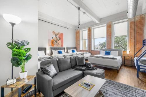 a living room with a couch and a bed at Stunning Downtown Apartment with Pool, Laundry, Parking in Dallas