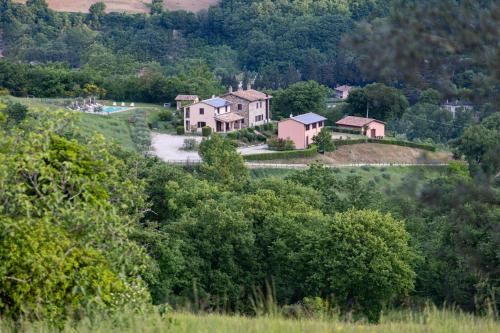 a house on top of a hill with trees at Relais Parco Del Subasio in Piano Delle Pieve