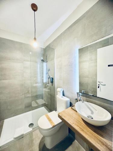 a bathroom with a sink and a toilet and a shower at La Siesta in La Maddalena