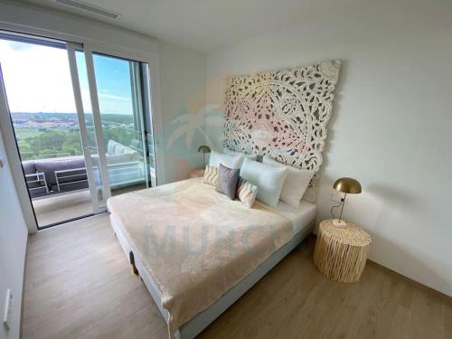 a bedroom with a bed and a large window at Limonero16 in Orihuela Costa