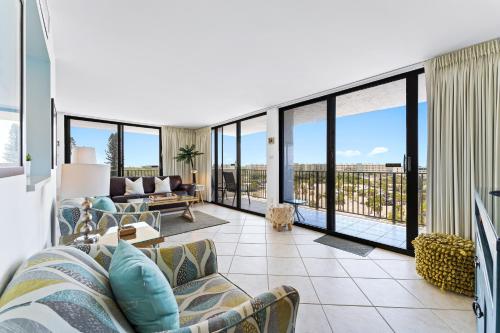 a living room with a couch and some windows at Our House at the Beach 604E By Beachside Management in Siesta Key