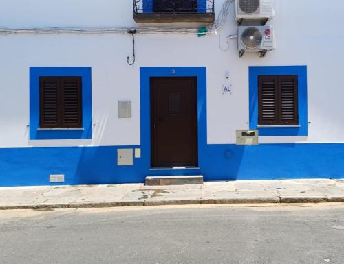 a blue and white building with a door and windows at A Lapa in Mourão
