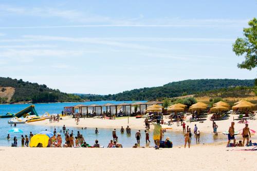 a group of people on a beach with umbrellas at Casa de Campo - Vila Boa in Vila Boa