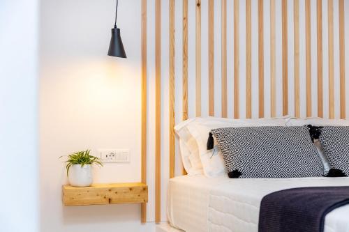 a bedroom with a bed and a potted plant at Alenor City Hotel in Naxos Chora