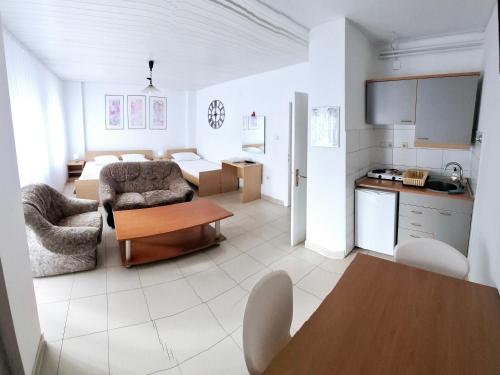 a kitchen and a living room with a table at Gago Apartments in Struga