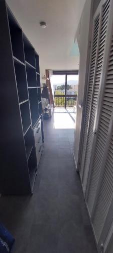 une chambre avec un couloir avec une porte et une chambre avec une fenêtre dans l'établissement Beau studio mer, à Saint-Cyprien