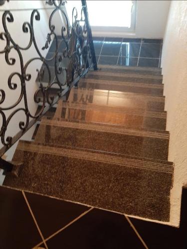 a set of stairs with a wrought iron railing at MEDINA in Sarajevo
