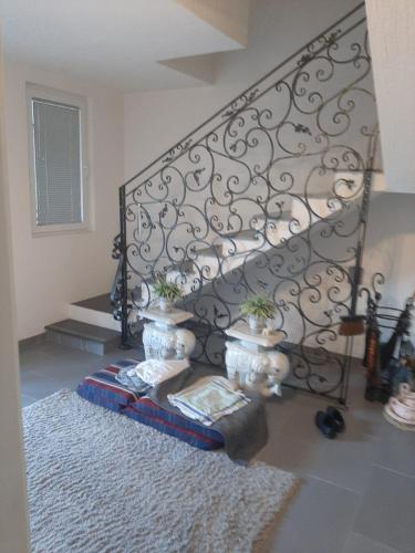 a staircase with a black iron railing and a rug at MEDINA in Sarajevo