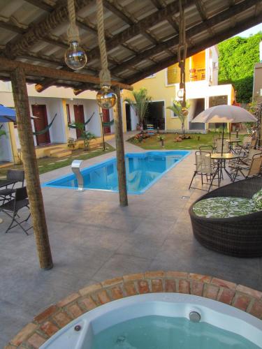 an outdoor swimming pool with a hot tub and a patio at Pousada Sr. Ivan in Serra do Cipo