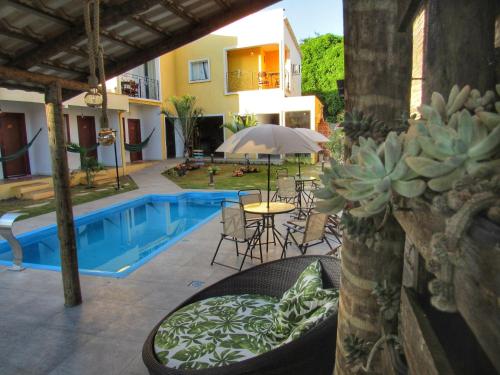 a patio with a pool and a table with a cactus at Pousada Sr. Ivan in Serra do Cipo