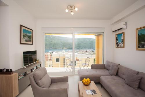 a living room with a couch and a table at Boka Panoramic in Đenovići