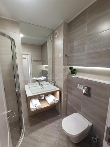 a bathroom with a toilet and a sink and a shower at Tranquilo Escapes in Sunny Beach