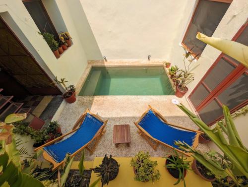 an overhead view of two chairs and a swimming pool at Casa Mi María in Campeche
