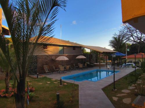 a swimming pool in front of a house at Pousada Sr. Ivan in Serra do Cipo