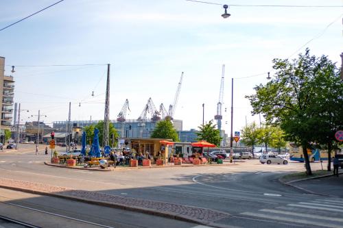 a busy city street with cranes in the background at Cozy and stylish studio in Kamppi in Helsinki