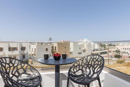 a table and two chairs on a balcony with a view at Alenor City Hotel in Naxos Chora