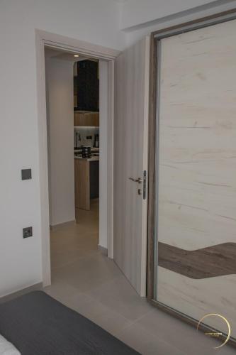 a sliding glass door in a room with a kitchen at Sunset Shores Mola Kaliva in Mola Kalyva