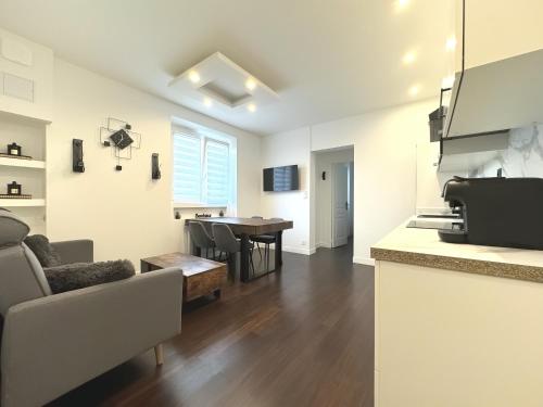 un salon avec un canapé et une table dans l'établissement Le Charmant Grenoble, à Grenoble