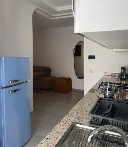 a kitchen with a white refrigerator and a sink at Costa Mar, Playa 5 in Martil
