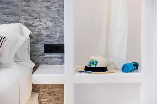 a hat sitting on a shelf next to a bed at Alenor City Hotel in Naxos Chora