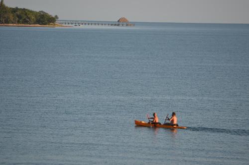 three people in a boat in the water at Belizean Nirvana in Placencia Village