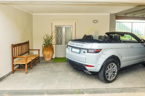 a car parked in a living room with a bench at Villa Paolina in Sulzano