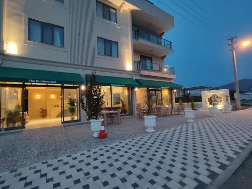 a building with a patio with tables and chairs at The Brothers Suite Dalaman in Dalaman