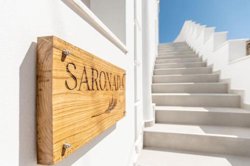 a wooden sign on the side of a stairs at Saronada Studio in Kinídharos