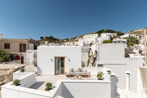 a white house with a view of the city at Saronada Studio in Kinídharos