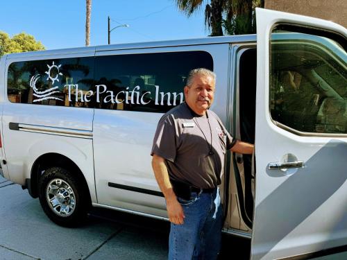 a man standing in front of a white van at The Pacific Inn in Seal Beach