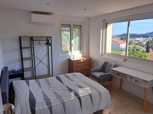a bedroom with a bed and a desk and a chair at Bas Villa, Vue mer, Centre ville, Paradis, calme in Hyères