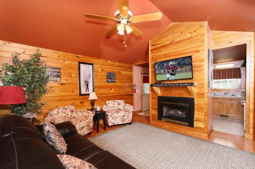 a living room with a couch and a fireplace at Pine Needles by Eden Crest in Pigeon Forge