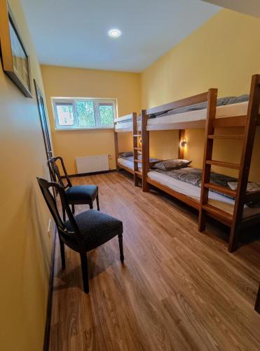 a room with two bunk beds and a chair at Ernests' unique townhouse with sauna, hot tub and free parking in Rīga