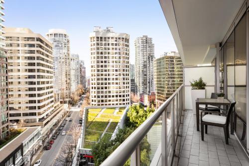 an apartment balcony with a view of a city at Hyatt Vancouver Downtown Alberni in Vancouver