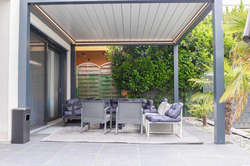 a patio with a table and chairs under a pergola at Luxury Vienna 6BR Villa with Private Pool & Sauna - Pets allowed in Vienna