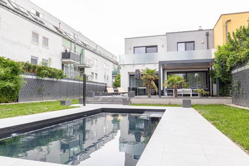 a swimming pool in the backyard of a house at Luxury Vienna 6BR Villa with Private Pool & Sauna - Pets allowed in Vienna