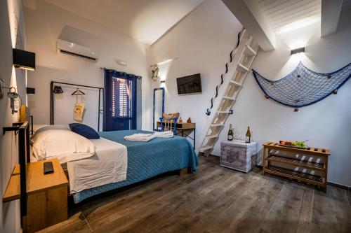 a bedroom with a bed and a staircase at Kalifè Vacanze in Castellammare del Golfo