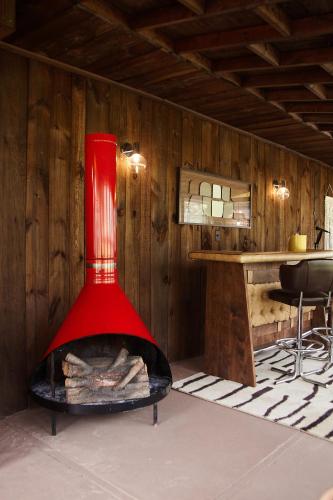 a red vase sitting over a fireplace in a room at Catskills Retro Retreat- Upstate Home W Hot Tub in Saugerties