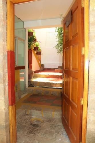an open door into a room with a hallway at Casa De Mama Cusco - The Treehouse in Cusco