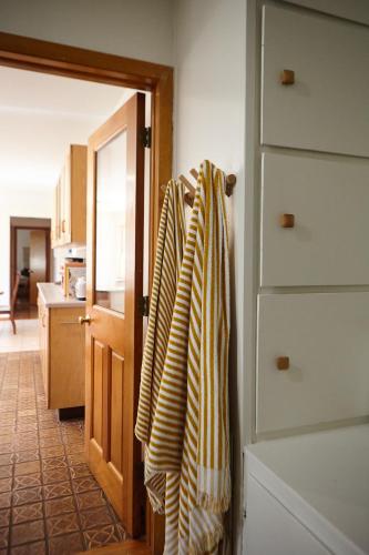 a room with a door with towels hanging on it at Catskills Retro Retreat- Upstate Home W Hot Tub in Saugerties