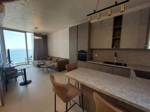 a kitchen and living room with a couch and a table at Palase Four C apartment 243-E GC in Palasë
