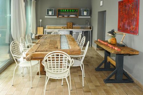 a dining room with a wooden table and chairs at Villa Paolina in Sulzano
