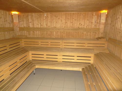 a sauna with wooden benches in a room at Rancho Laaxdeluxe in Laax