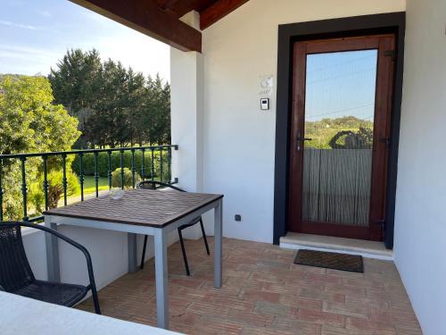 a patio with a table and chairs and a door at Quinta Fronteira in Bensafrim