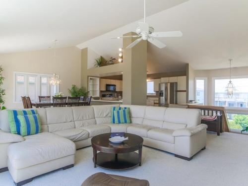 a living room with a white couch and a table at As Good As It Gets in Surf City