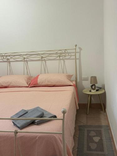 a bedroom with a bed and a table with a lamp at Sardegna Pittulongu in Olbia
