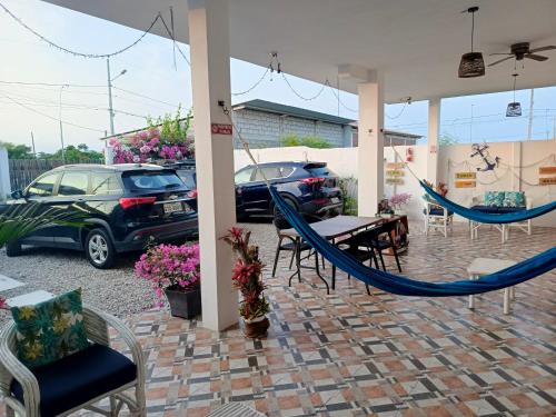 a patio with two hammocks and a table and chairs at Sol de Ayangue in Ayangue
