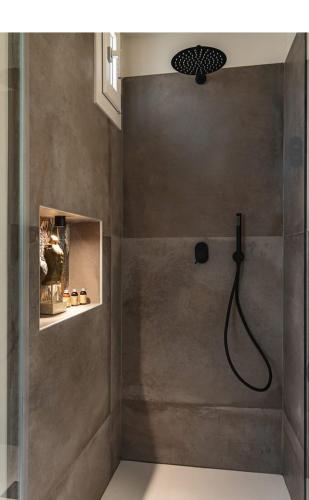 a bathroom with a shower with a shower head at MATTEI LUXURY B&B in Altamura