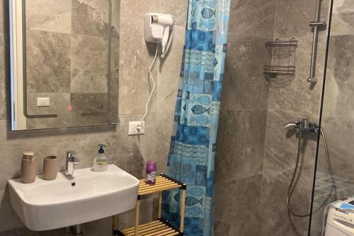 a bathroom with a sink and a shower at Palase Four C apartment 190-A GC in Palasë