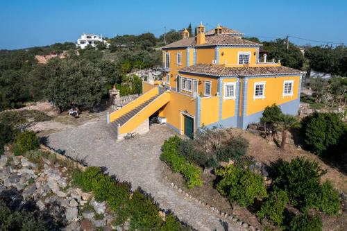 an aerial view of a yellow house on a hill at AL Monte Lusitano in Loulé